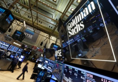FILE - In this Aug. 15, 2014, file photo, a lighted sign marks the Goldman Sachs trading post on the floor of the New York Stock Exchange. Goldman Sachs reports quarterly financial results on Thursday, July 16, 2015. (AP Photo/Richard Drew, File)